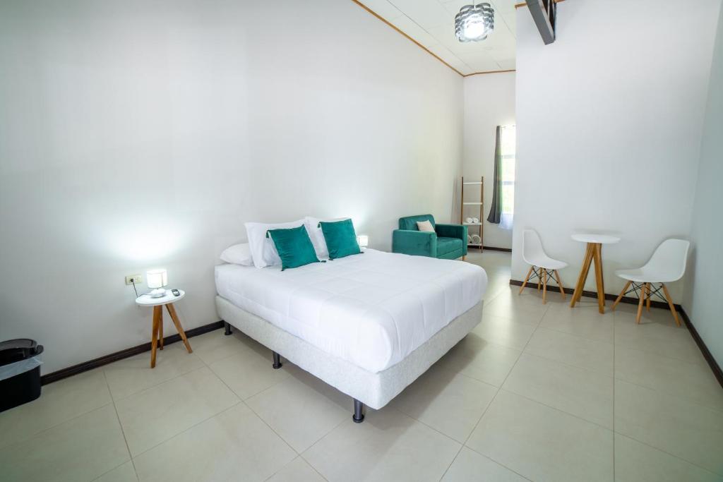 a bedroom with a bed and a table and chairs at Natüra Hotel Monteverde in Monteverde Costa Rica