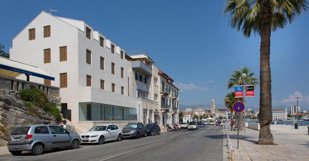 a street with cars parked on the side of a building at Apartment Toni Delux in Split