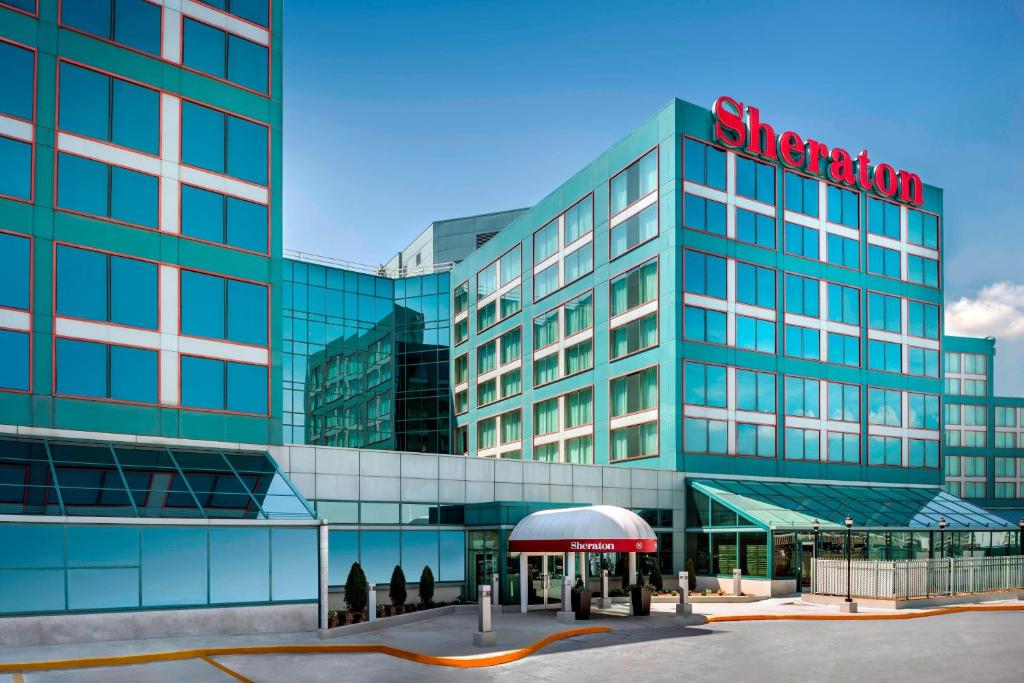 a large glass building with a sign on it at Sheraton Gateway Hotel in Toronto International Airport in Mississauga