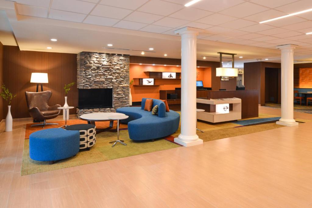a lobby with blue furniture and a fireplace at Fairfield Inn & Suites by Marriott Santa Cruz in Santa Cruz