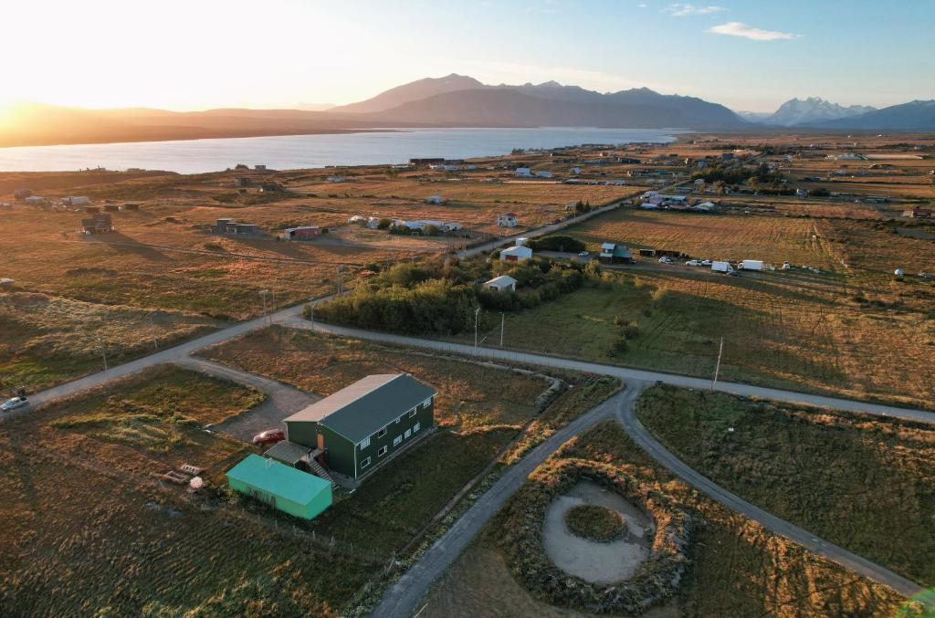 an aerial view of a farm with a truck at Hotel Casa Verde in Puerto Natales