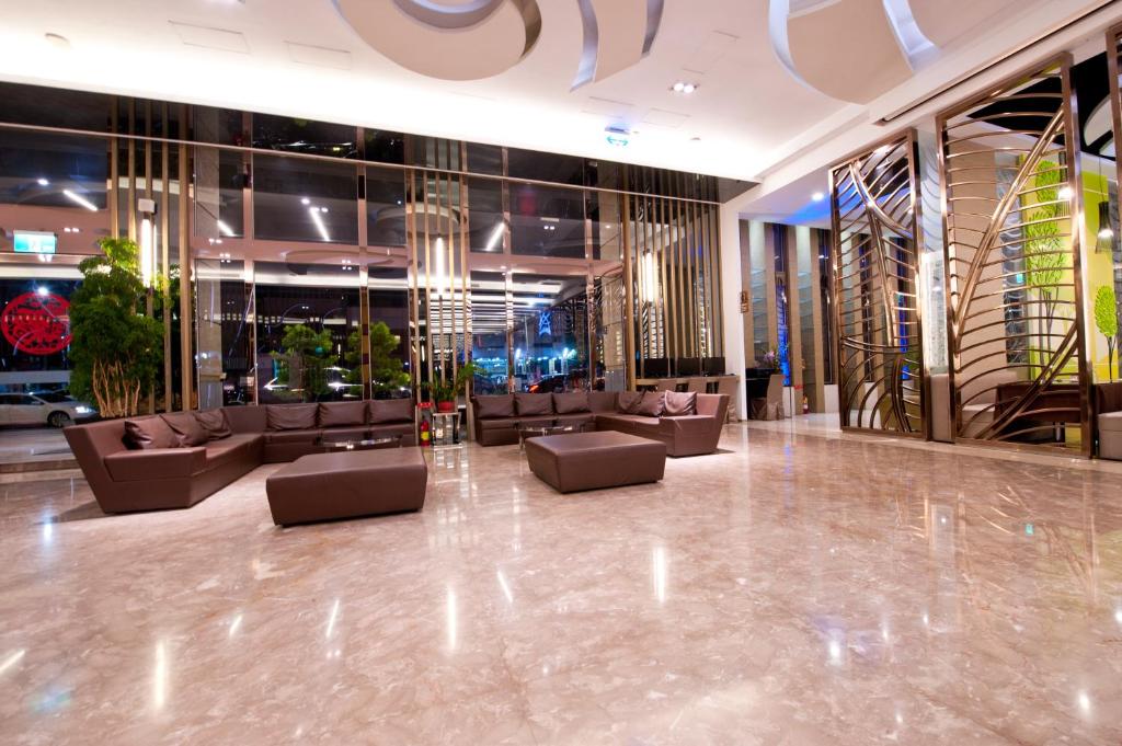 a lobby with couches and tables in a building at Tsun Huang Hotel in Chiayi City