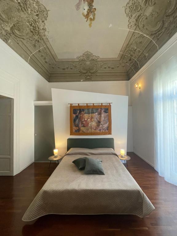 a bedroom with a bed with a painting on the ceiling at Costa Suites in Palermo