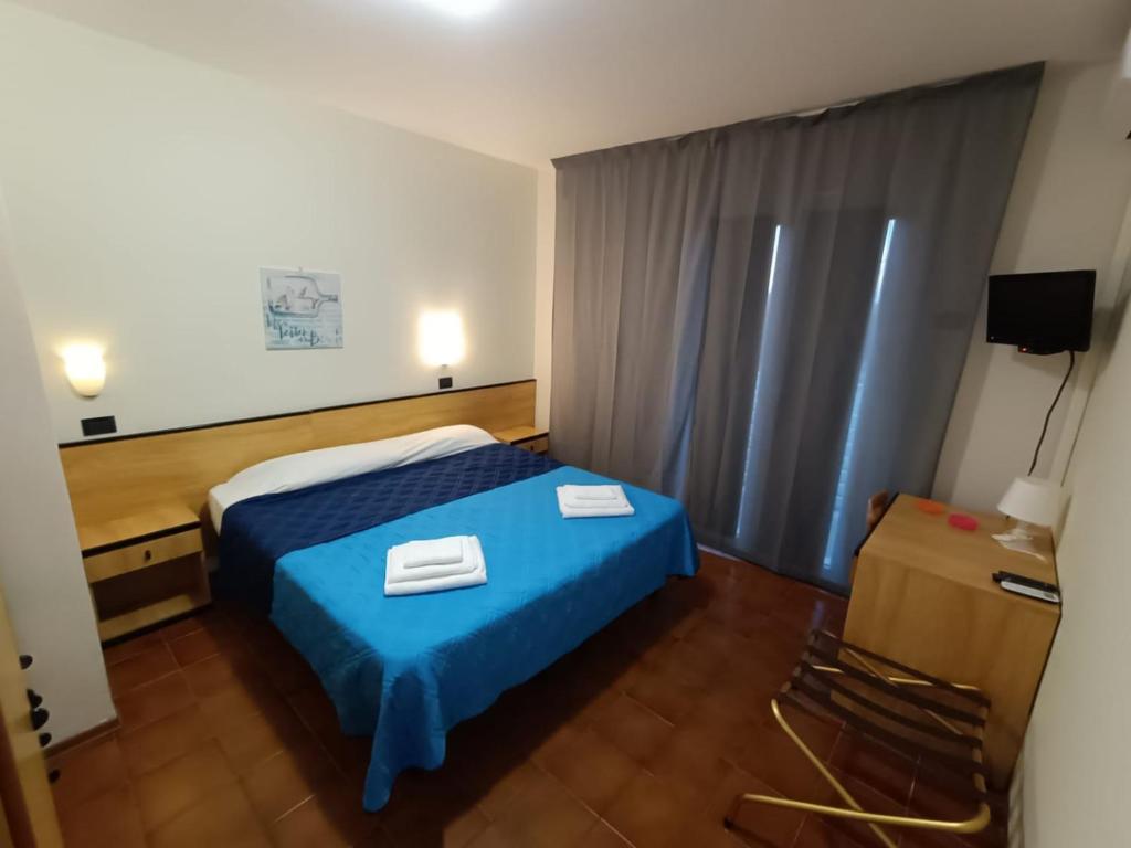 Postel nebo postele na pokoji v ubytování Hotel La Torre