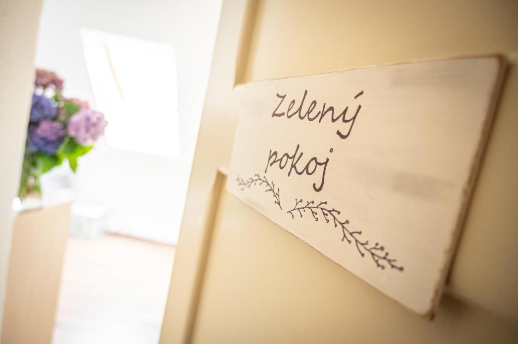 a sign on the door of a room with flowers at Vila Lumír in Poděbrady