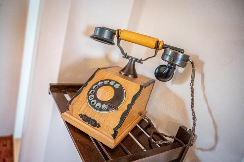 a wooden phone is hanging on a wall at Vila Lumír in Poděbrady