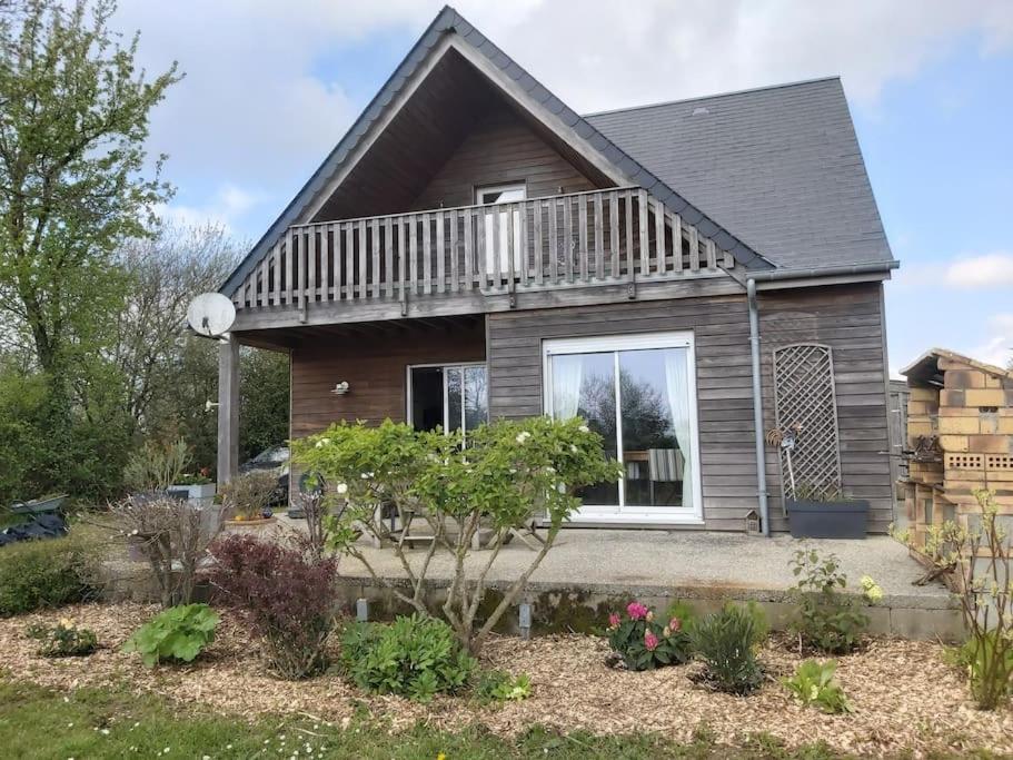 une maison avec un balcon au-dessus dans l'établissement Maison proche des plages 6 personnes au maximum, à La Haye-dʼEctot