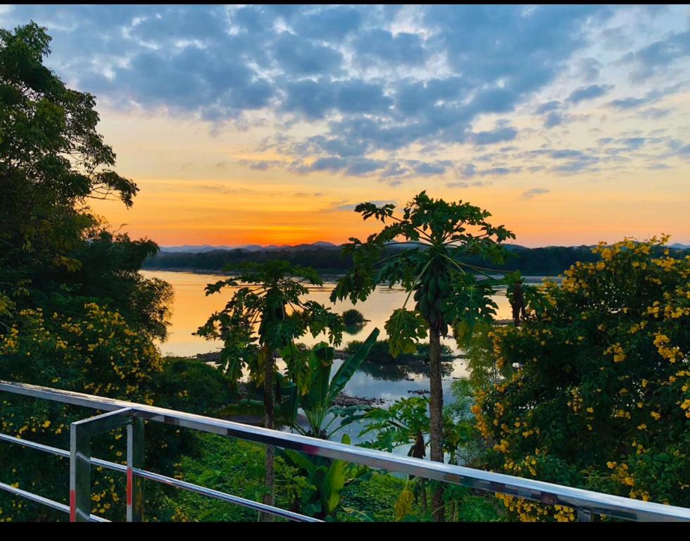 a view of a river at sunset from a balcony at Chiang Khan Riverside Bungalows in Chiang Khan