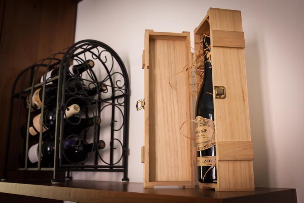 a bottle of wine sitting next to a wine rack at La Maison di Luca in Verona