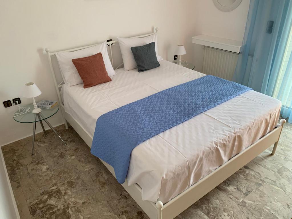 a bedroom with a large bed with pillows on it at Panormo House in Panormos Rethymno