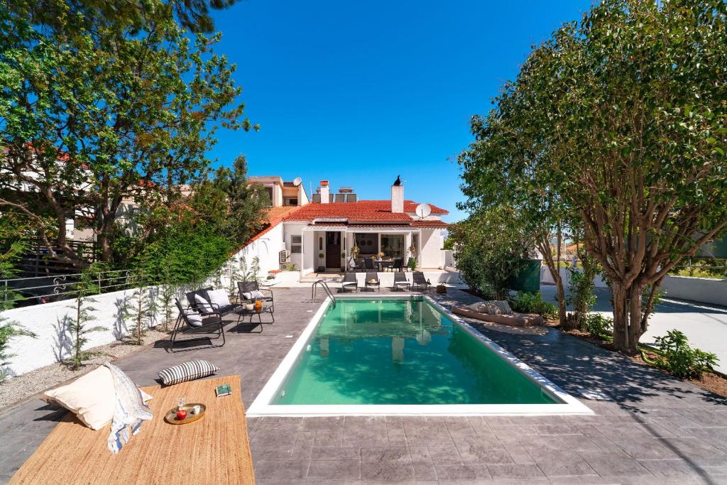 a swimming pool in the backyard of a house at Ixian Bliss Pool Villa in Ialysos
