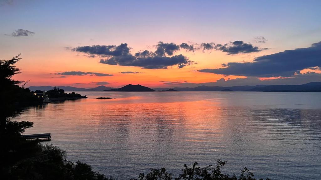 a sunset over a body of water with mountains at Sofia Ada in Fethiye
