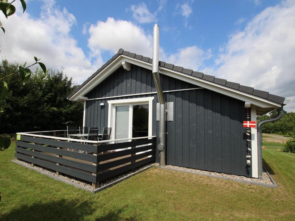 a black shed with a pitched roof at Holiday home Tversted, Zarrentin in Zarrentin