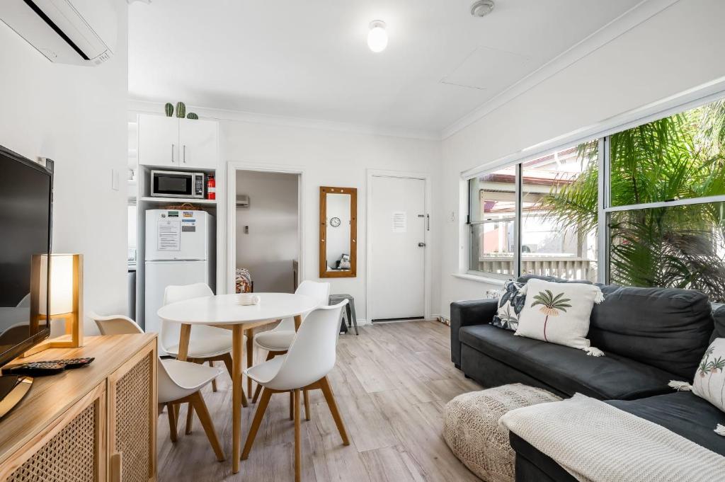 a living room with a couch and a table at Central and modern 2 bedroom unit at Smugglers in Victor Harbor