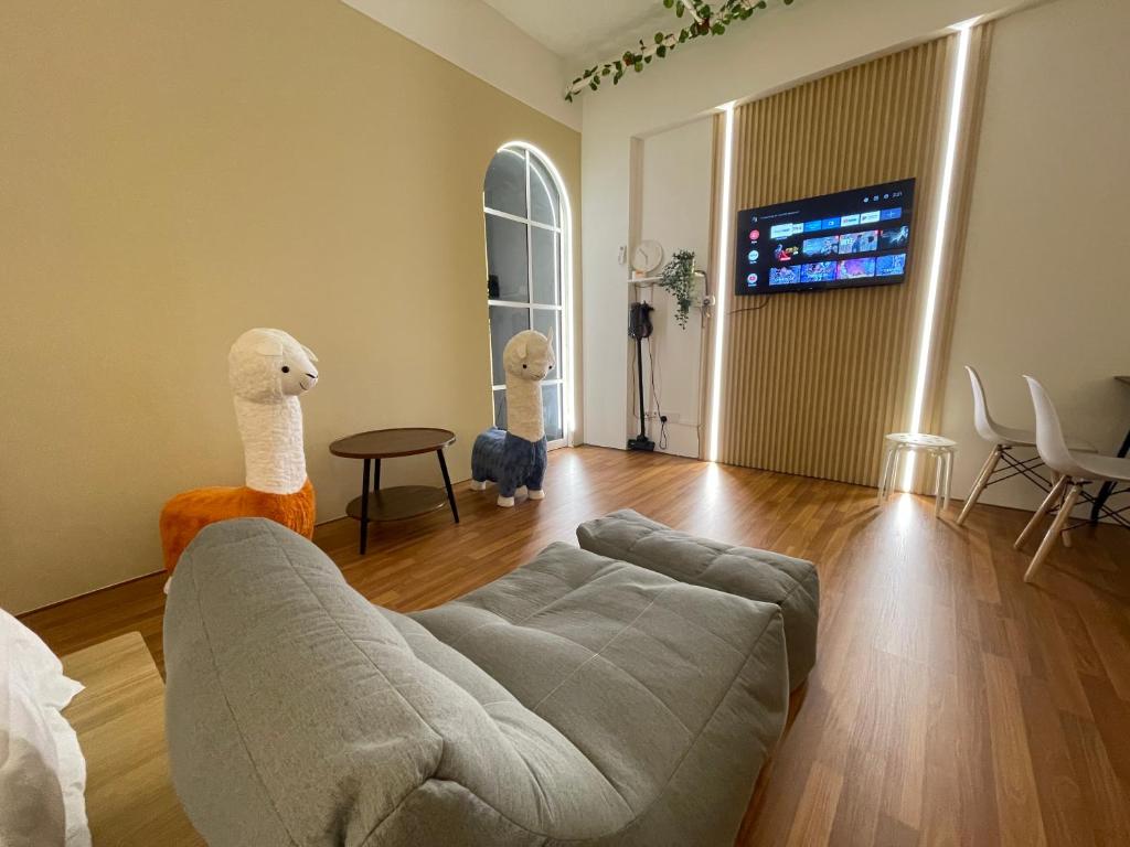 a living room with a couch and a tv at Central of Sunway Town; 8 PAX in Petaling Jaya