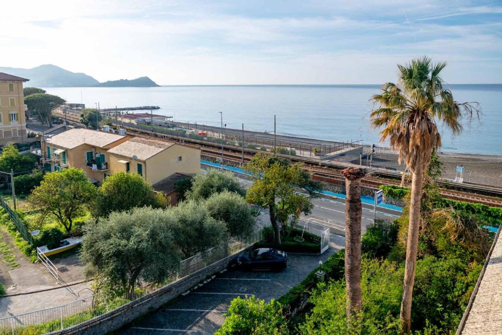 a view of the ocean from a building with a palm tree at Real Park Hotel in Cavi di Lavagna