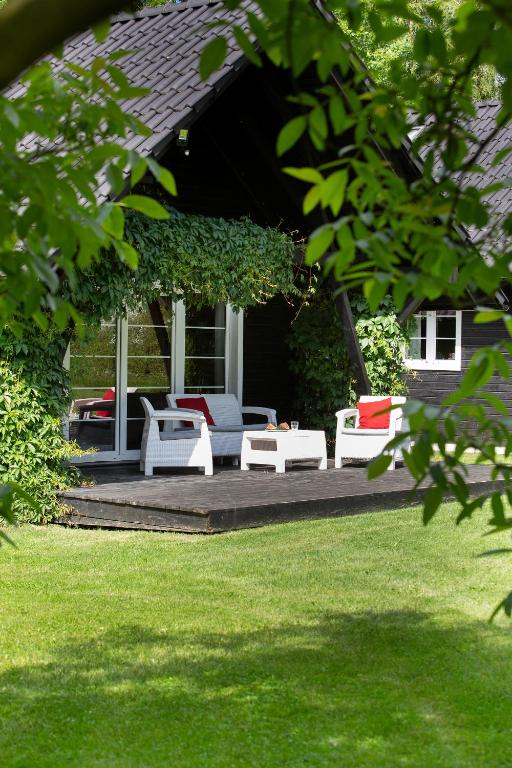 a porch with white furniture on a house at Bukolik in Bukowiec