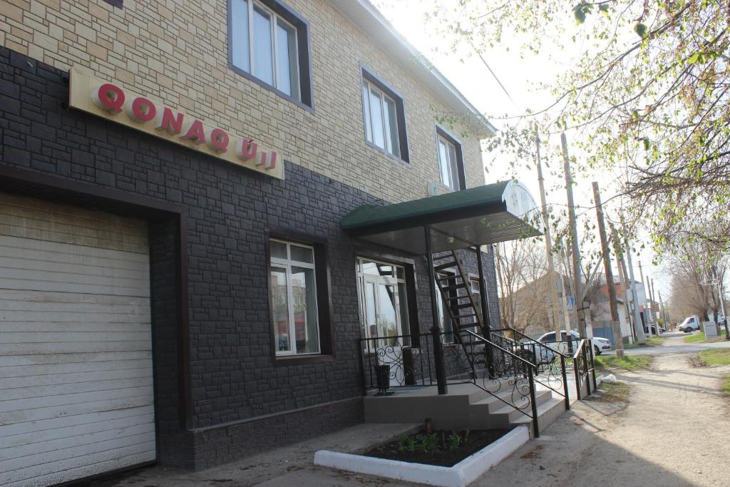 a brown brick building with a sign on it at Бутик-отель Мажор in Aktobe