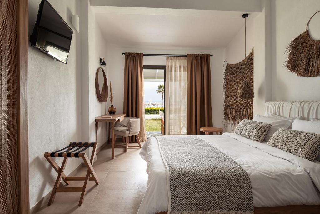 Postel nebo postele na pokoji v ubytování Bungalows Iphigenia