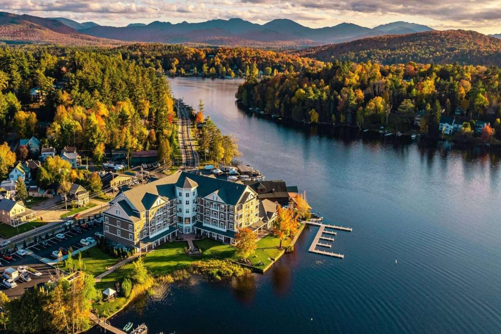 an aerial view of a mansion on a lake at Saranac Waterfront Lodge in Saranac Lake