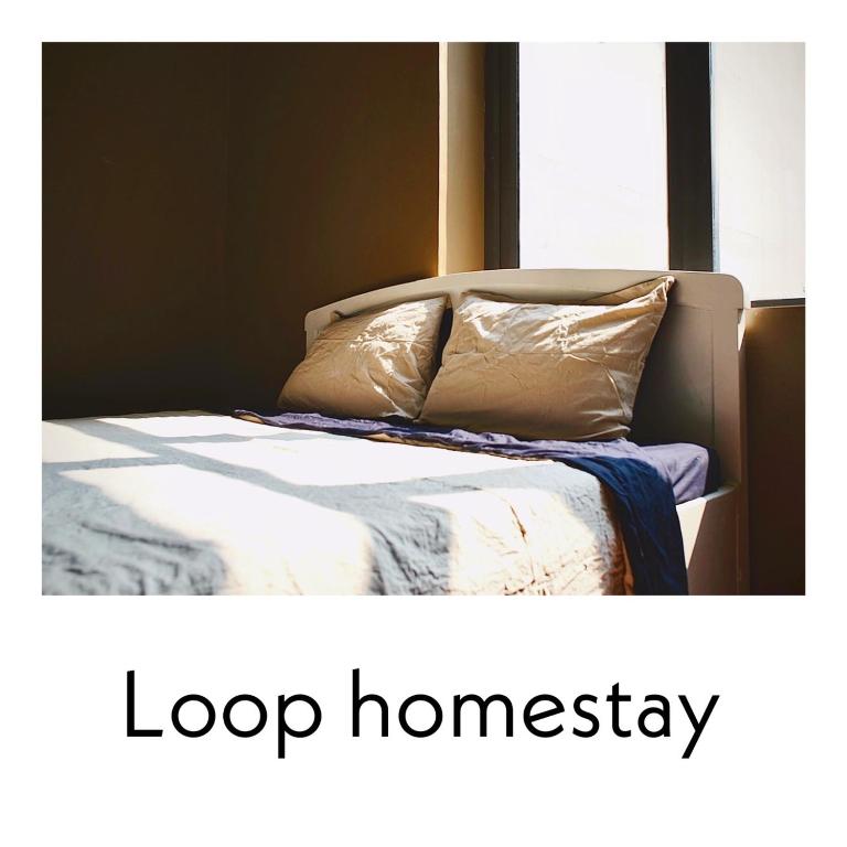 a bed with a white comforter and two pillows at Loop Homestay in Thương Xà (2)