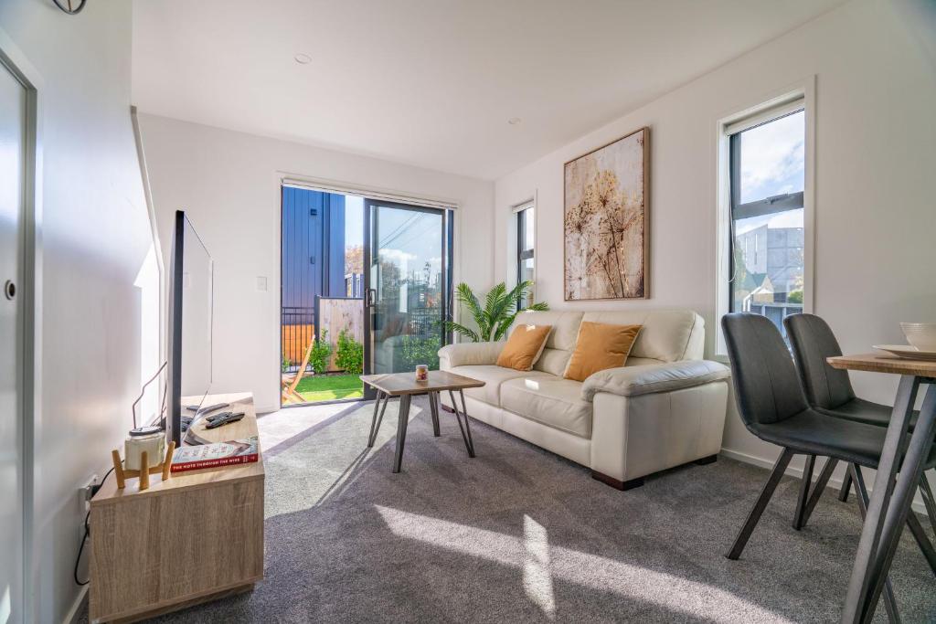 a living room with a couch and a table at King bed on Hagley Park corner in the CBD in Christchurch