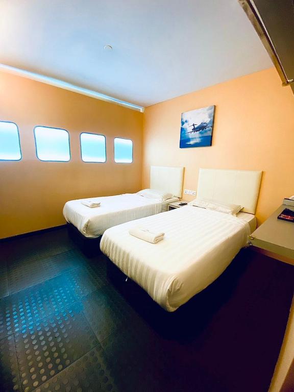 Postel nebo postele na pokoji v ubytování Sri Langit Hotel KLIA, KLIA 2 & F1