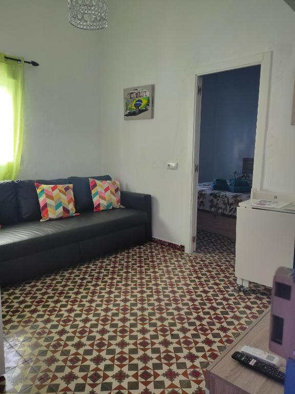 a living room with a couch and a carpet at Estudio Alicia in Rota