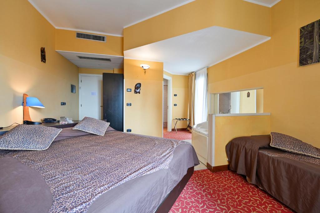 a hotel room with two beds in a room at Hotel Europa in San Bartolomeo al Mare
