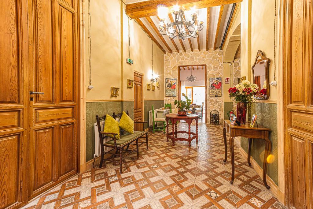a hallway with a table and chairs in a building at Boutique B&B Suite at Casa Grande in Pinoso