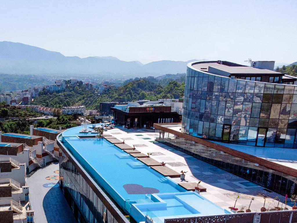 a hotel with a swimming pool on top of a building at Arka Art Hotel in Tirana