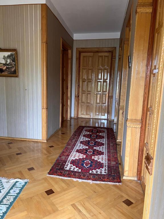 an empty room with a rug on a wooden floor at Rest and go on in Khashuri