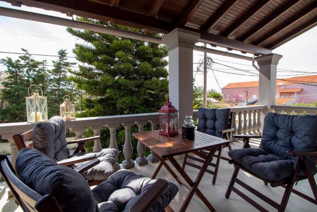 une terrasse couverte avec des chaises et une table. dans l'établissement Georgia Apartment Acharavi Corfu, à Acharavi