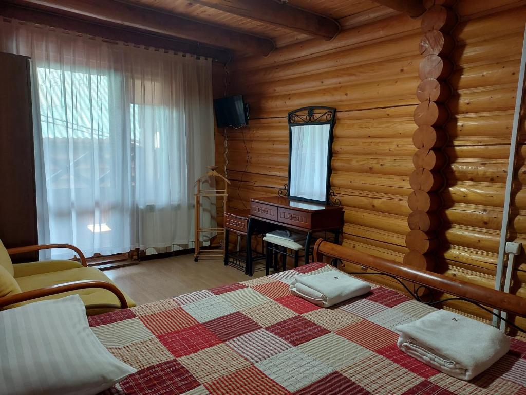 Postel nebo postele na pokoji v ubytování Urochyshe Vyshnya