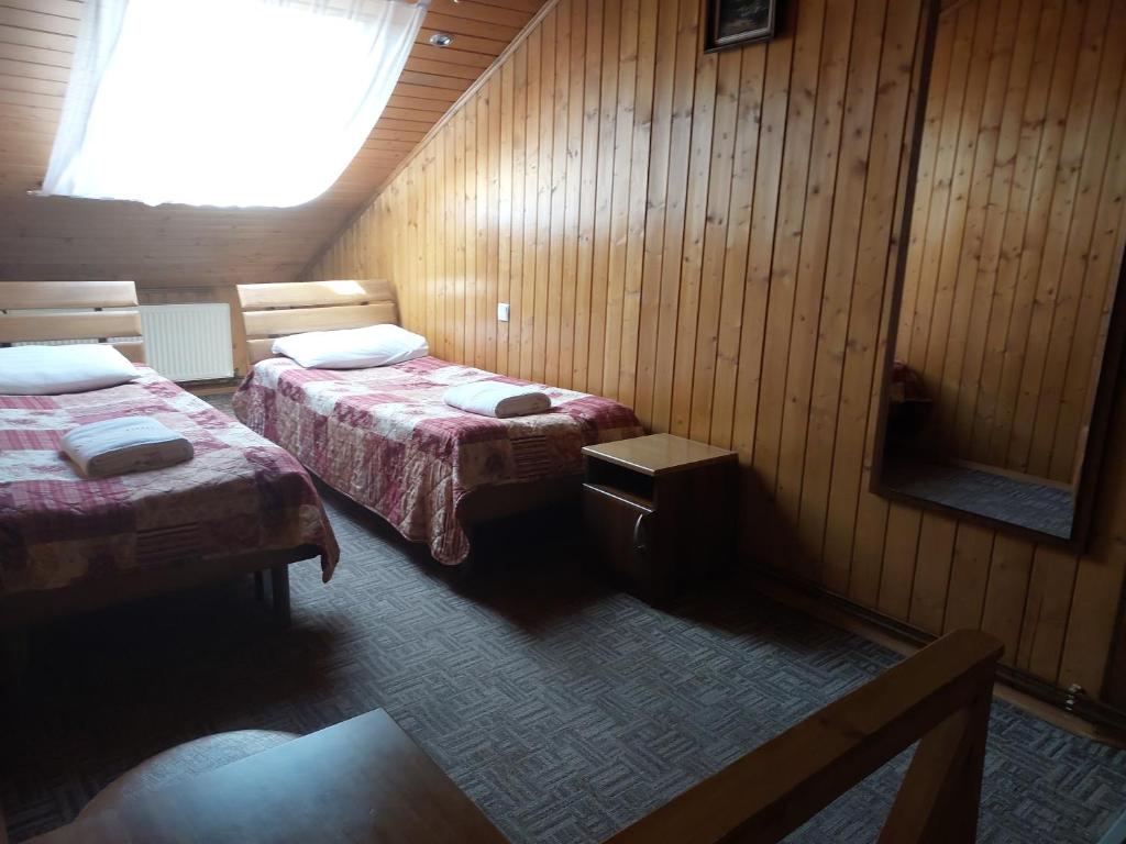 Postel nebo postele na pokoji v ubytování Urochyshe Vyshnya
