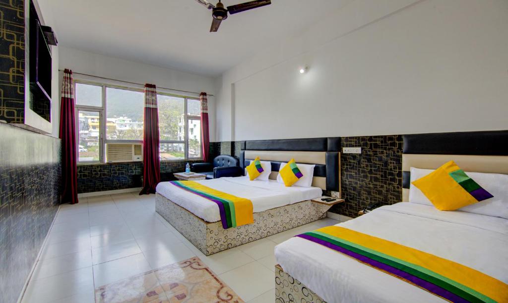 a hotel room with two beds and a window at Itsy By Treebo - Satya Shree in Katra