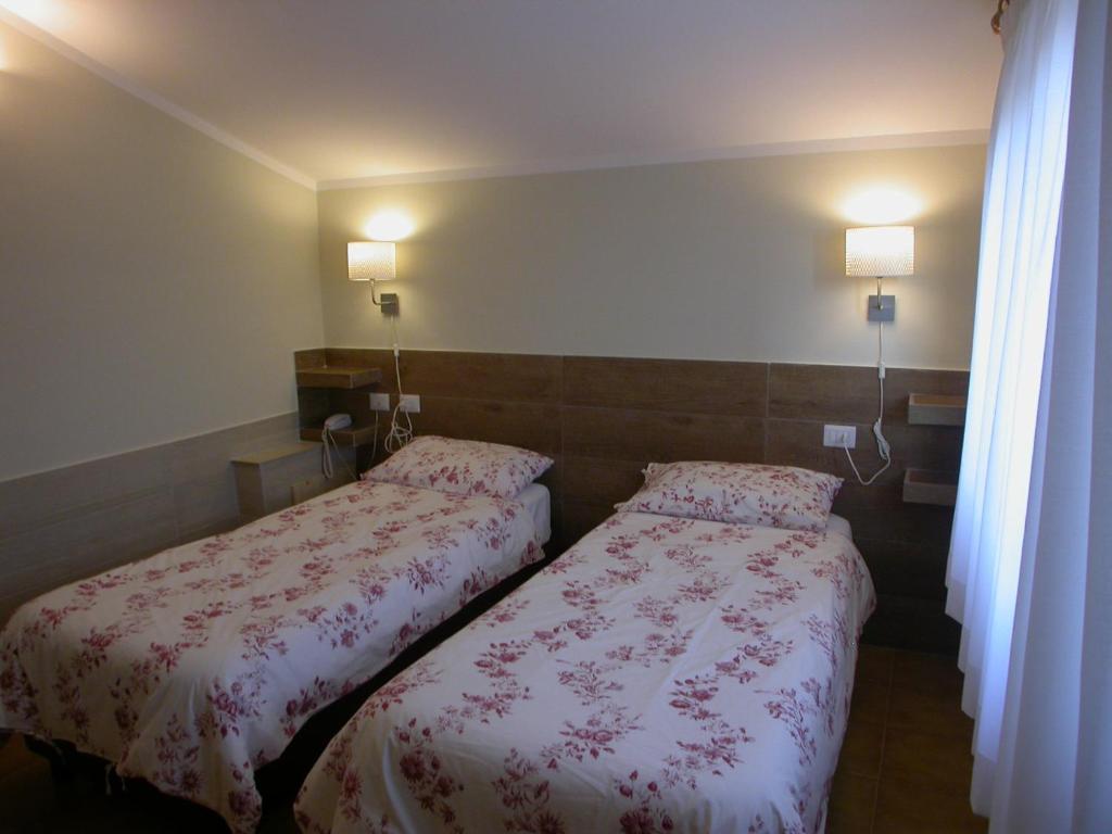 Postel nebo postele na pokoji v ubytování Hotel Il Roscio