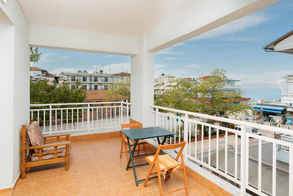 a balcony with a table and chairs and a view at Villa Estelle in Paralia Katerinis