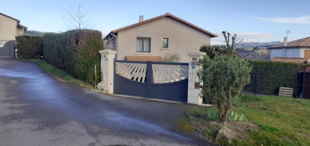 a blue gate in front of a house at Studio Wifi SdB à l'italienne in Chauffailles