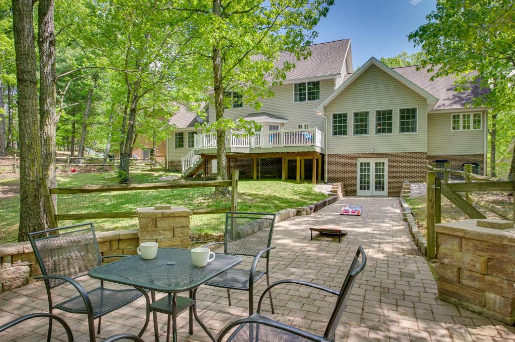 a patio with a table and chairs in front of a house at Massanutten Home Rental with Sauna and Game Room! in McGaheysville