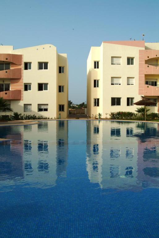 a swimming pool in front of two buildings at MOHAMMEDIA 304 in Mohammedia