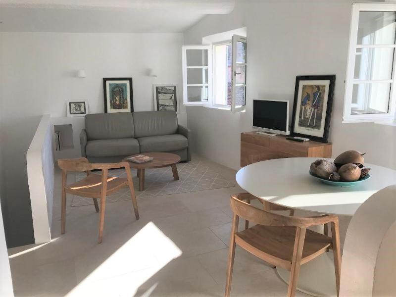 a living room with a couch and a table at VILLAGE - DUPLEX lumineux avec vue magnifique sur les toits in Saint-Tropez