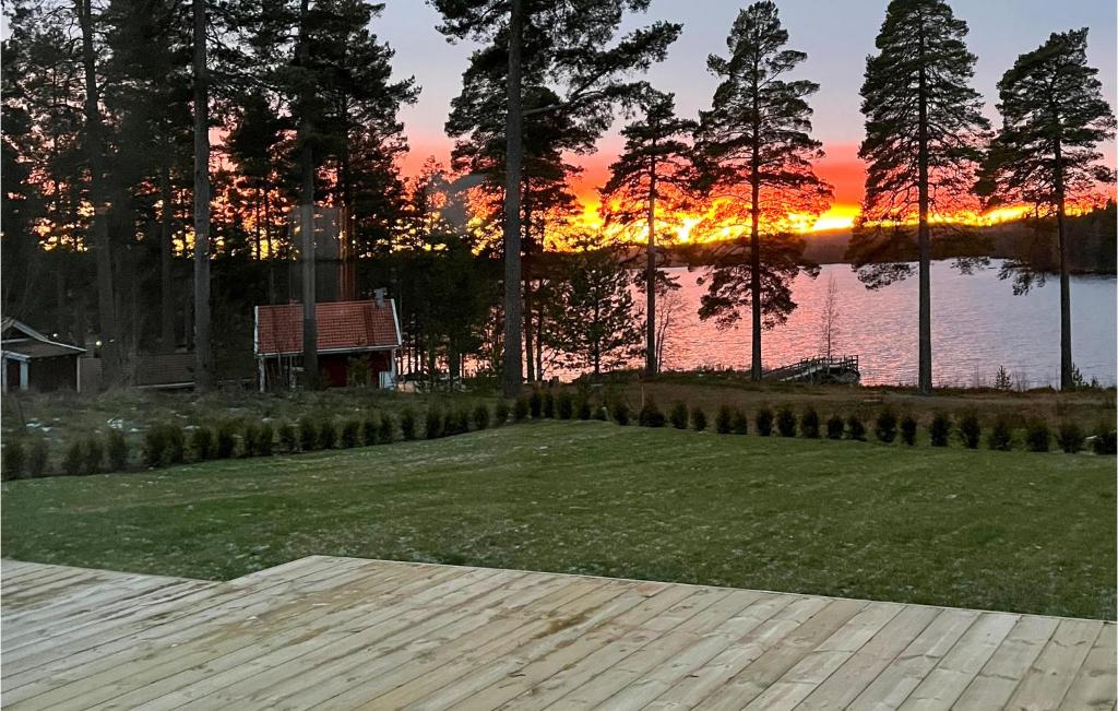 a grassy area with a sunset in the background at Beautiful Home In Idkerberget With 2 Bedrooms in Grangärde