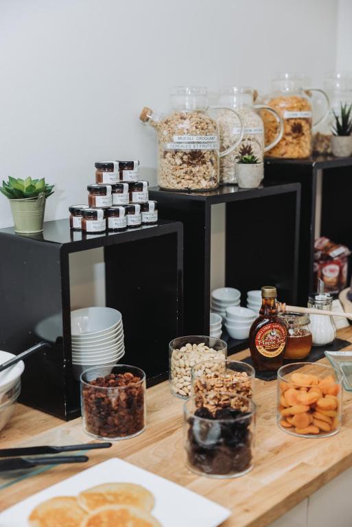 a table topped with lots of different types of food at Hôtel La Villa Cannes in Cannes