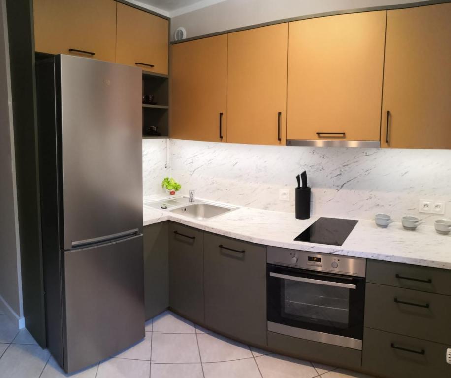 a kitchen with a stainless steel refrigerator and a sink at Apartament w Zdroju in Duszniki Zdrój