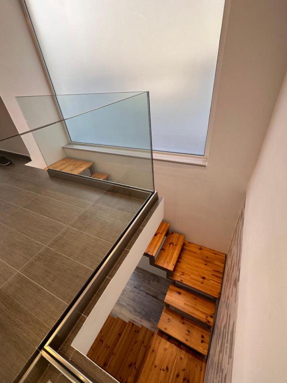 a house with a glass ceiling and wooden stairs at Rodini Inn in Rhodes Town