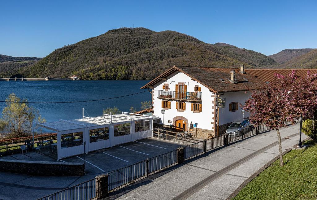 a house on a dock next to a body of water at Hostal Etxeberri in Eugi