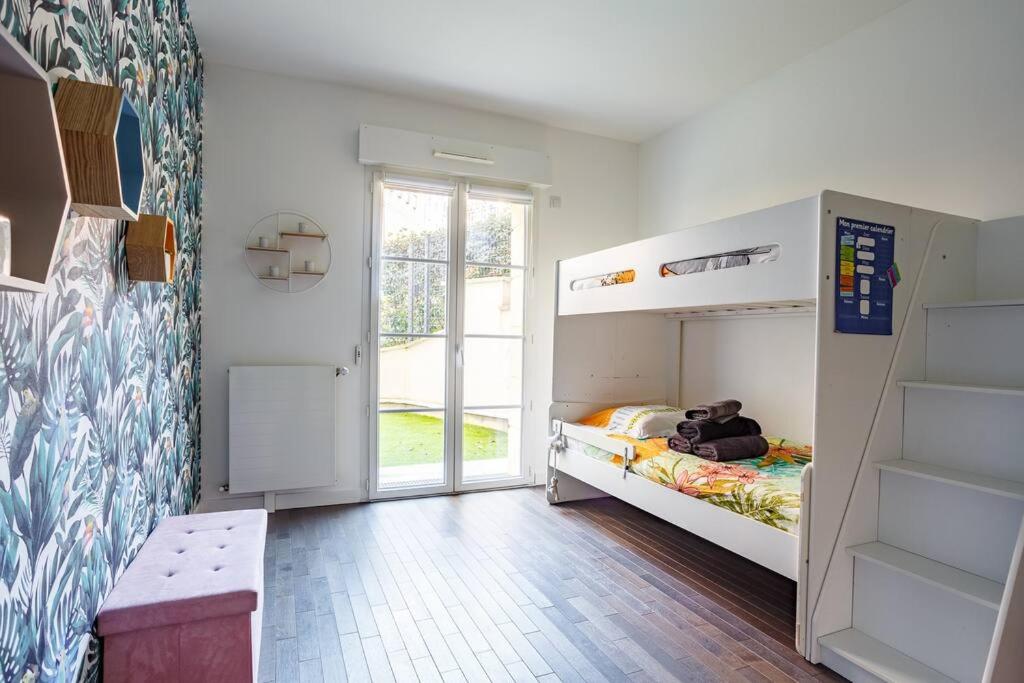 a small bedroom with a bunk bed and a window at Apt 6P - Standing RER Tram Paris Orly Velizy in Le Plessis-Robinson