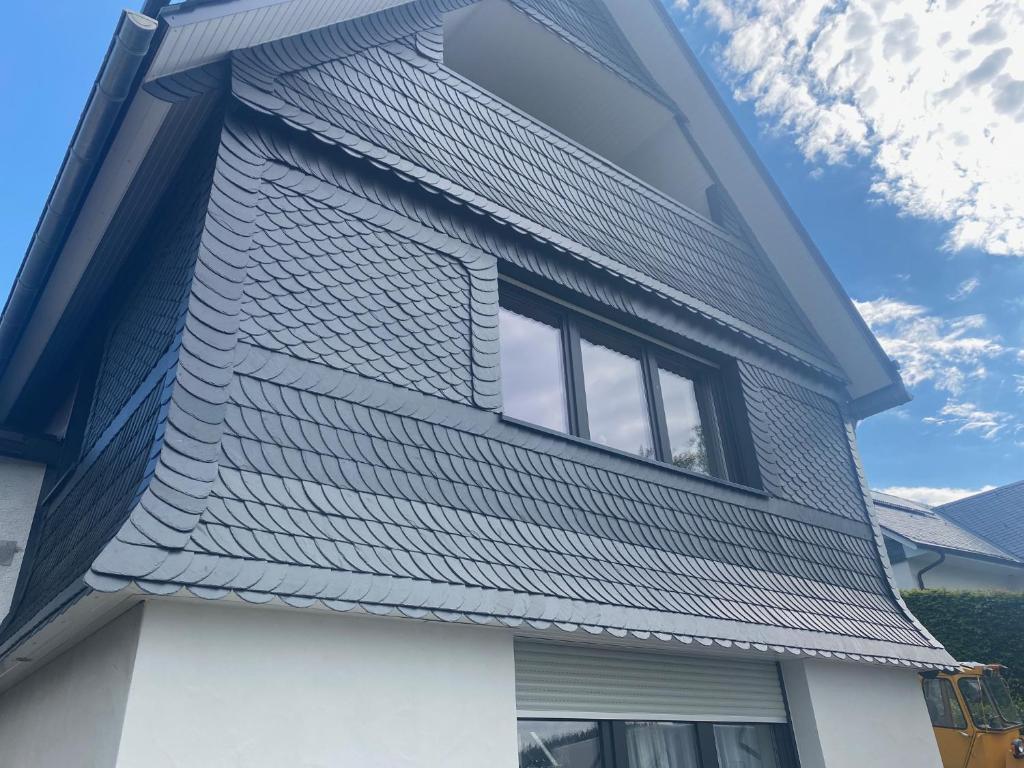 a house with a metal roof on top of it at Astrid's Appartements in Winterberg