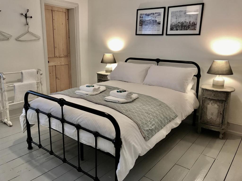 a bedroom with a bed with two towels on it at Delightful Seaside Binnacle Cottage -hosted by Whitstable-Holidays in Whitstable
